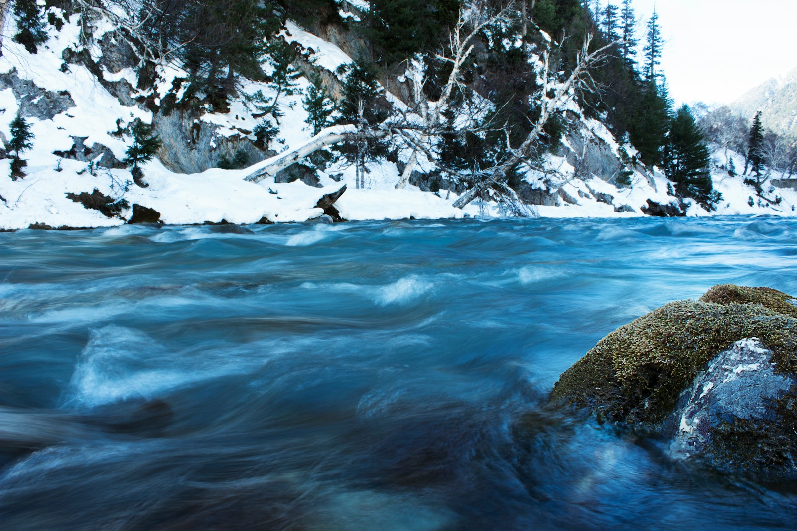a river running through a snow covered forest